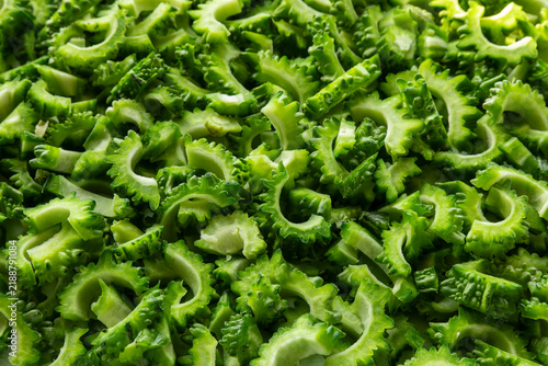 Tilted view of bitter melon chunks, selectively focused, prepared for cooking.