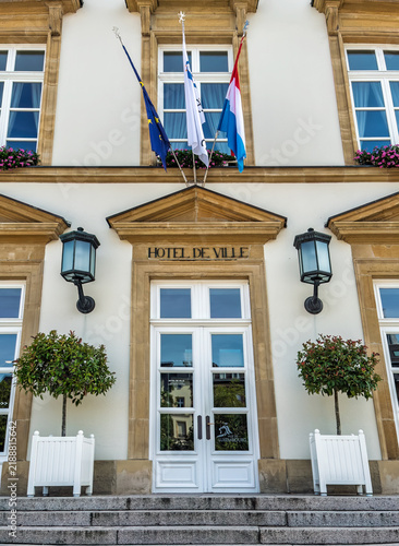 Luxembourg City, Luxembourg, Europe - July 24, 2026: City Hall, Hotel de Ville, front facade, focused on main entrance decorated with flags, lanterns, and flowers