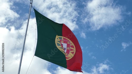 Portuguese Flag Waving in the Blue Sky with Clouds