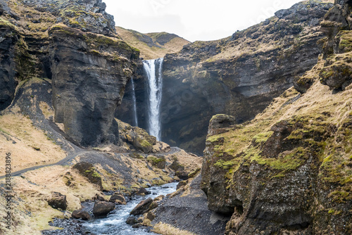 the trail to visit the Kvernufoss waterfall located in a deep rocky canyon in the southern part of Iceland on a cloudy day in March