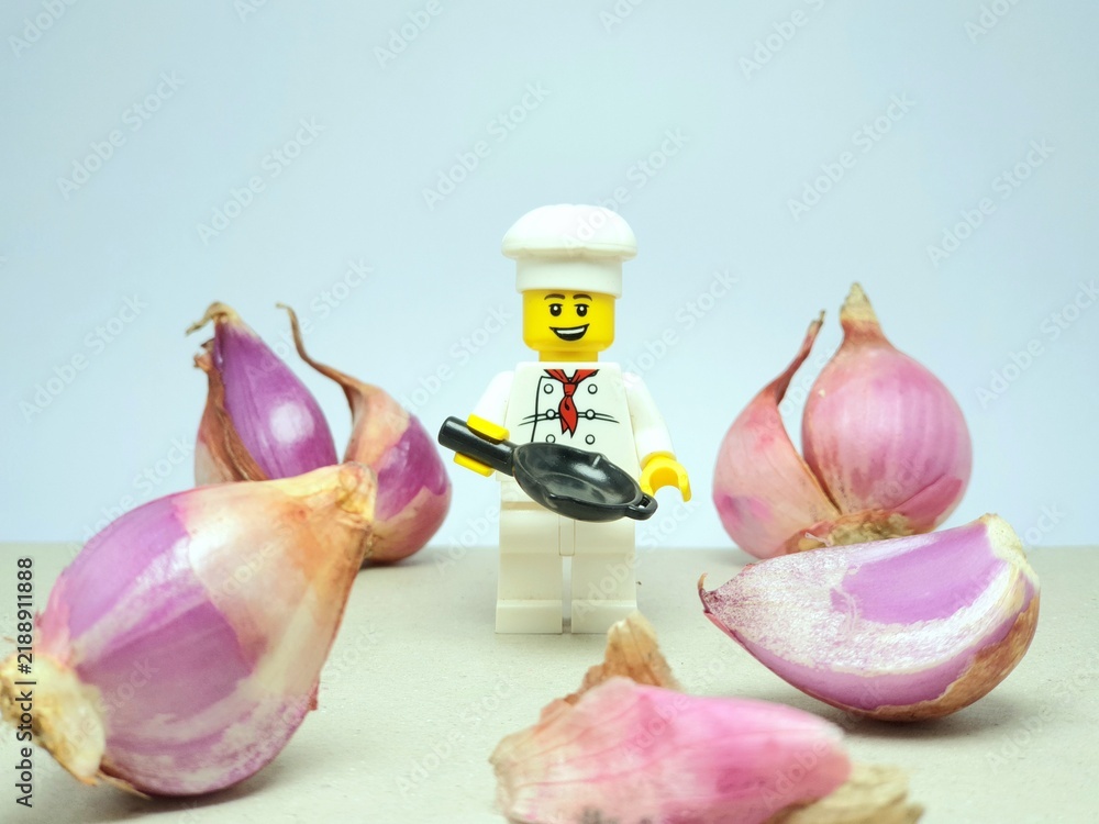 Fototapeta premium Indonesia - November 16, 2023 : Mini toy figure at table with blurred background. Chef concept design. Miniature photography.