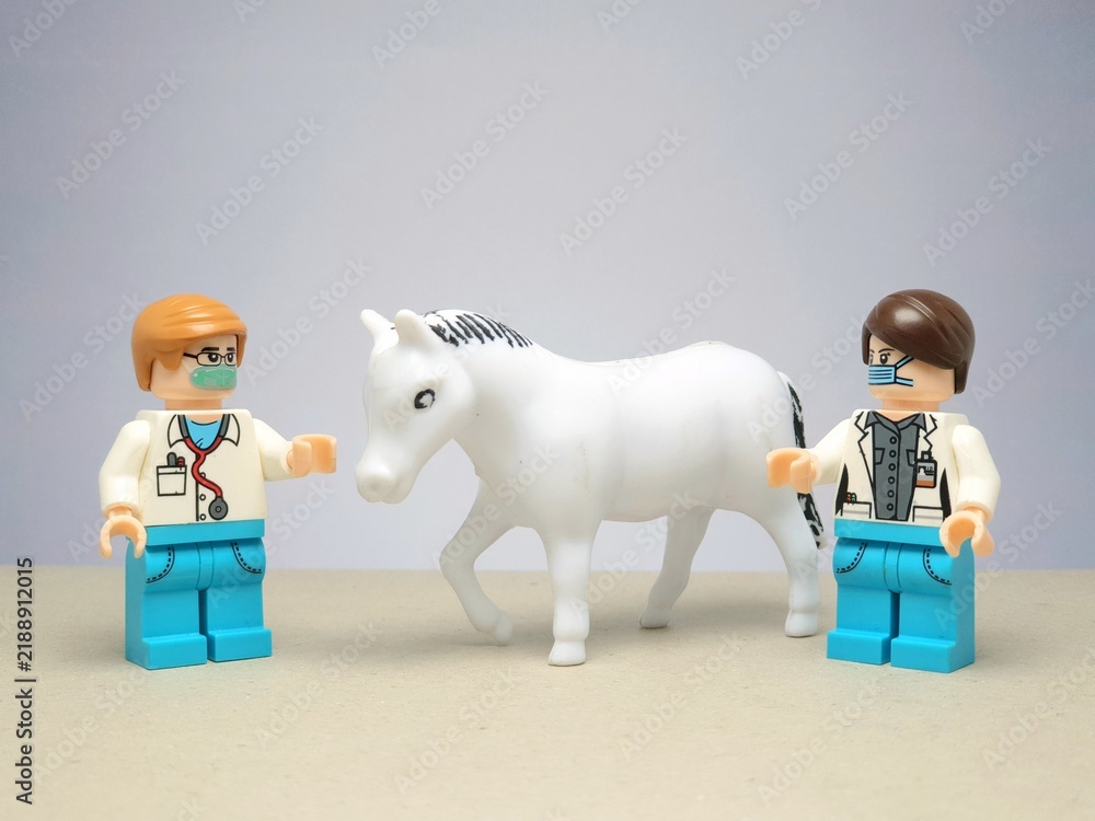 Fototapeta premium Indonesia - November 24, 2023 : Mini toy figure of lego at table with blurred background. Miniature photography concept design.