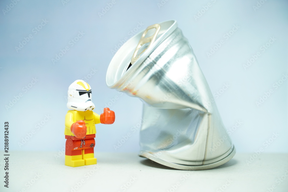 Obraz premium Indonesia - November 10, 2023 : Mini toy figure of lego at table with blurred background. Boxing man hit the sack concept design. Stormtrooper character from Star Wars film.