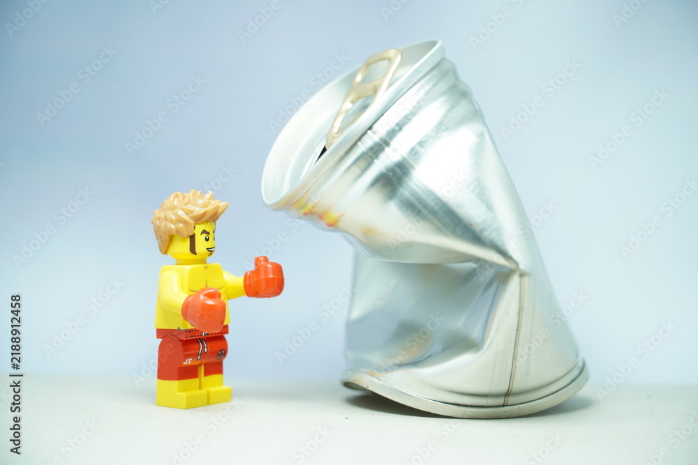 Fototapeta premium Indonesia - November 10, 2023 : Mini toy of lego at table with blurred background. Boxing man hit the sack concept design.