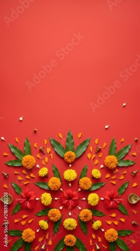 Minimalist festive flatlay with marigold and hibiscus flowers on red background for Durga Puja and Dussehra celebration