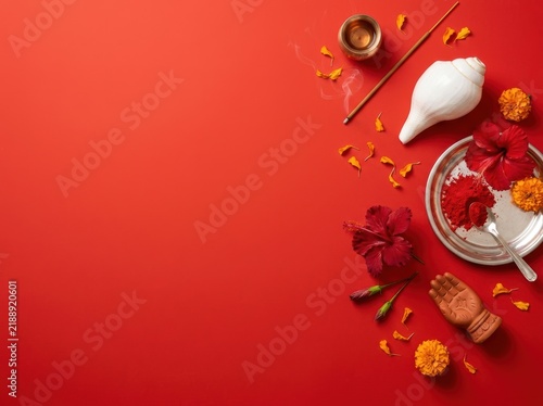 Durga Puja Visarjan Ritual Items Flatlay on Red Background with Copy Space; Traditional Offerings of Conch, Hibiscus, Vermilion, and Marigold for Indian Festival Celebration Banner
