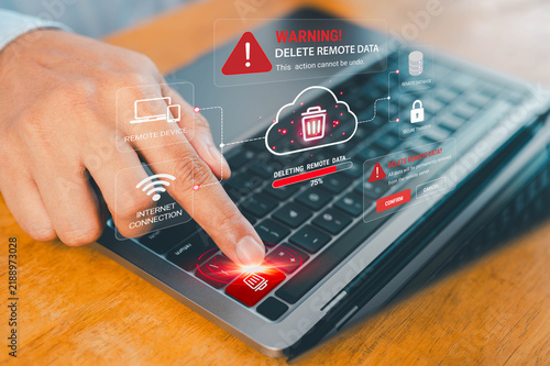 Remote data deletion warning on a laptop shows cloud storage, secure transfer, internet connection and device controls, illustrating cybersecurity, data loss, privacy risk and remote management.