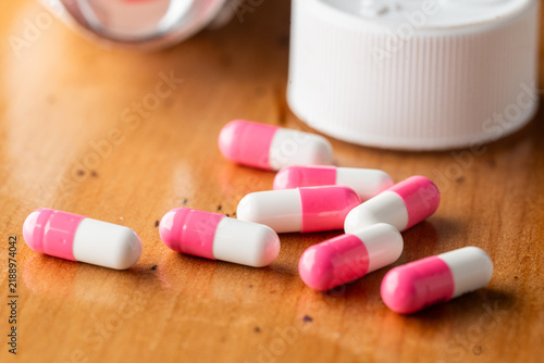 pink and white tablets on a wooden table