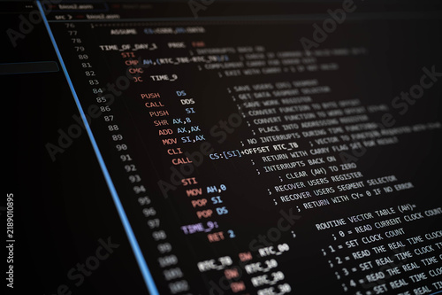 Naklejka Low level programming code displayed on a dark computer screen, illustrating assembly language, software development, computer engineering, machine instructions, debugging, and system programming.
