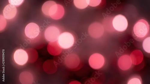 Soft red and pink circular bokeh light background.