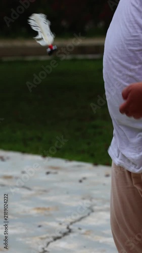 Man Playing Sipa by Kicking a Traditional Shuttlecock