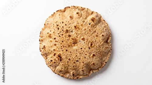 Crispy round papadum flatbread isolated on a simple surface