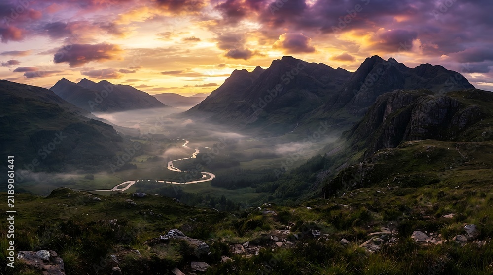 Obraz premium Mountain valley landscape glows under a dramatic sunset sky.