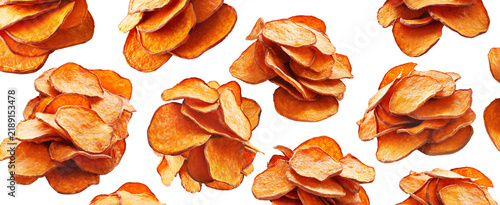 Piles of sweet potato chips placed randomly, isolated on white background, concept of healthy snack food