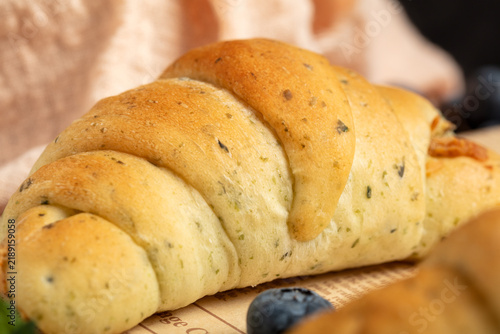 Cuadro en lienzo Freshly Baked Herb Croissant with Blueberry Garnish