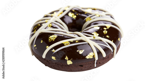 Quadro su tela Decadent chocolate donut with white icing drizzle and gold leaf flakes, isolated