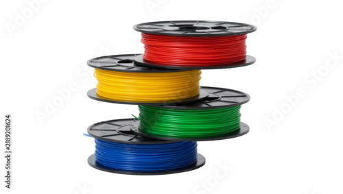 Stack of four colorful 3D printer filament spools, isolated on transparent background