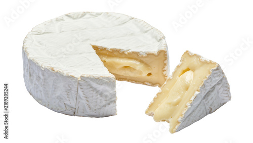 Whole round brie cheese with a wedge removed showing creamy interior, isolated on transparent background
