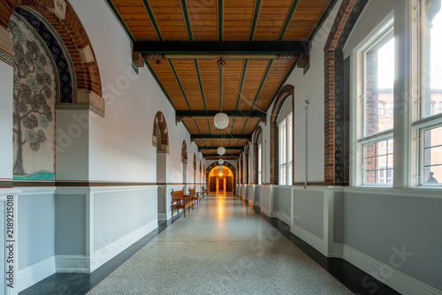 Long, ornate hallway with arched windows and decorative murals. Copenhagen