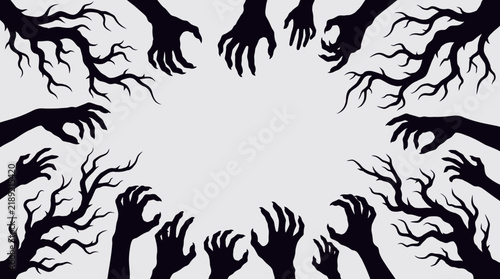 Reaching zombie hands and creepy bare branches frame Halloween horror border copy space   