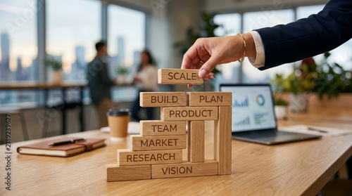 Hand building business strategy with plan and scale blocks