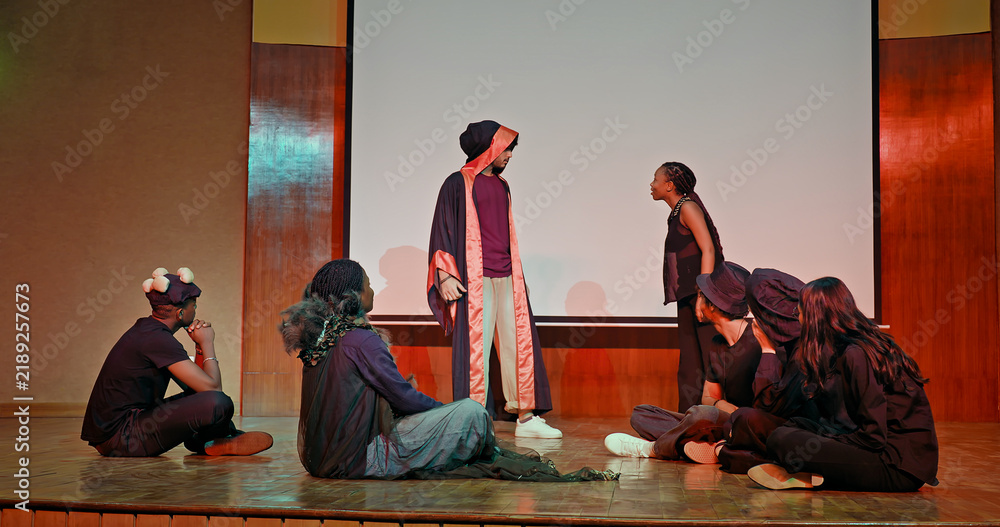 Obraz premium Indian young adult gen z lady female male man do drama practice standing studio indoor hall. Happy girl boy group enjoy scene have fun joy new day time inside campus place