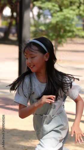 Happy Young Thai Girl Running and Playing at Lumpini Park Playground