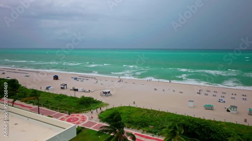 Beautiful view of Miami Beach shoreline and Atlantic Ocean beneath dramatic storm clouds.