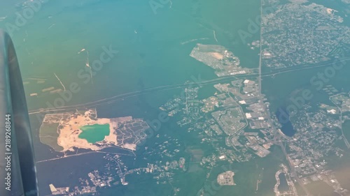 Beautiful view of Miami coastal cityscape and waterways from airplane window after takeoff. Miami. USA.