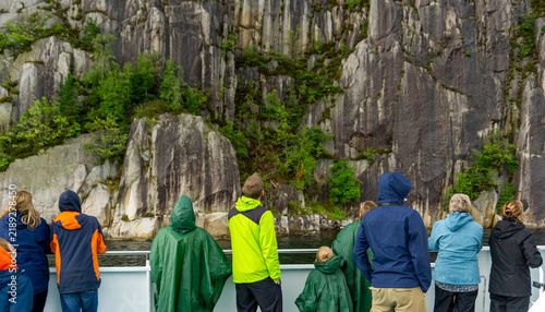 Принти на полотні Tourists watching Preikestolen cliff and Lysefjord landscape from boat tour