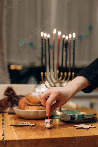 Hand spinning dreidel during hanukkah celebration