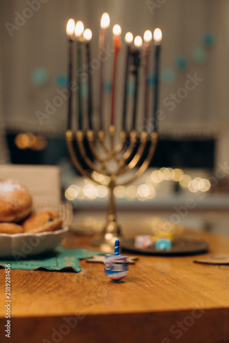 Dreidel spinning on table during hanukkah celebration