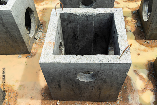 Obraz na płótnie Open square concrete drainage chamber showing deep interior and thick reinforced