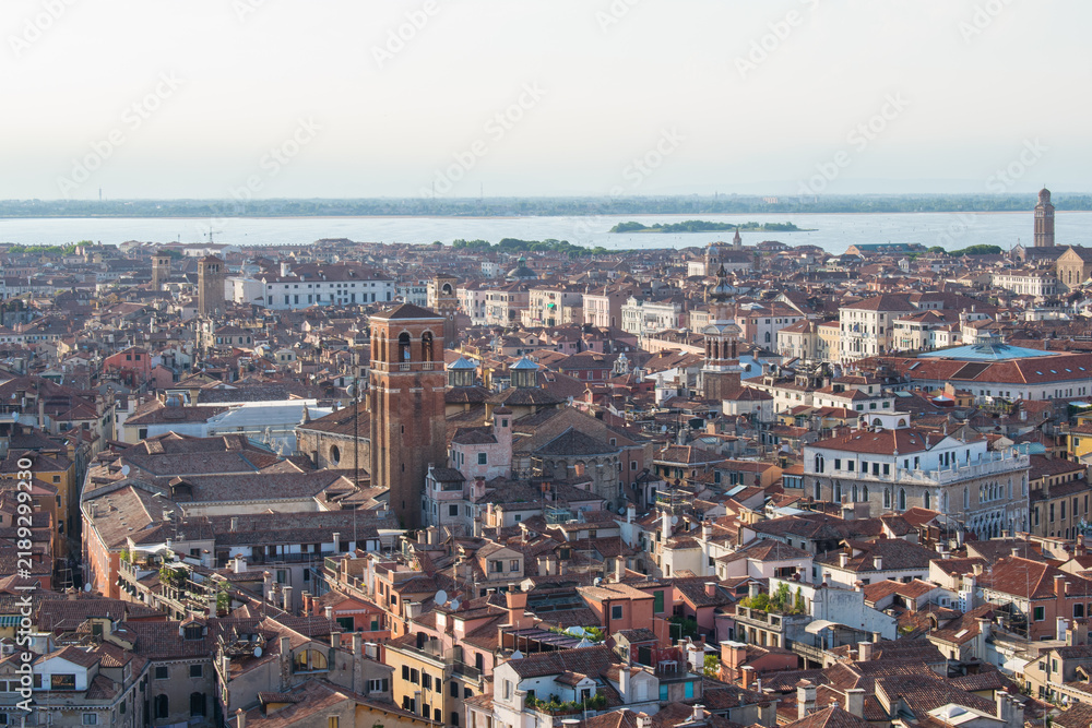 Obraz premium Aerial view of Venice's red-tiled rooftops overlooking the Grand Canal and lagoon