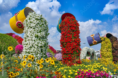 Cups with pouring water installations in the Miracle Garden of Dubai, UAE