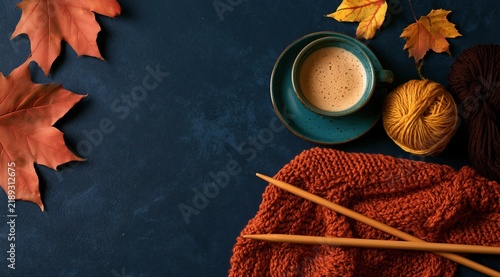 Cozy fall knitting scene with yarn balls and hot coffee