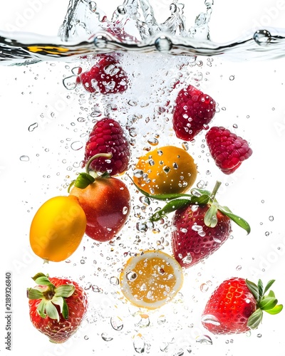 fruit pieces falling into sparkling water isolated on white background