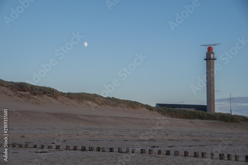 Lighthouse and Moon Over the Dunes of Westkapelle, Zeeland, Netherlands