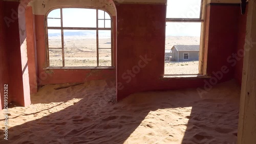 Interior view of an abandoned house in kolmanskop filled with sand within the namib desert.