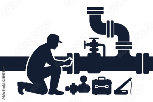 Industrial professional inspecting pipe system with professional hand tools in a commercial facility or plant