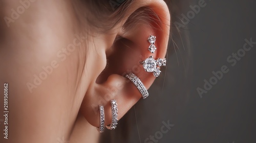 Close-up of stylish ear piercings with jewelry.