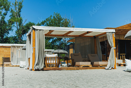 Obraz na płótnie Relaxation space at a beach resort with sun loungers and shaded cabanas