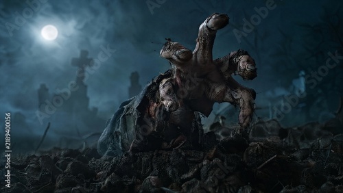 Spooky zombie hand emerging from grave dirt in a foggy graveyard at night, full moon illuminating the eerie scene, horror concept for Halloween, dark blue and gray tones