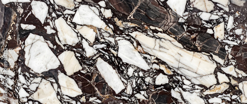 Black and white marble texture with fragmented mosaic pattern and gold accents creating a dramatic luxury natural stone background