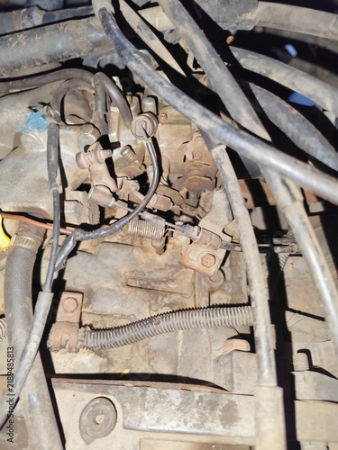 Принти на полотні Detailed view of an old car engine bay showing the carburetor, throttle linkage,