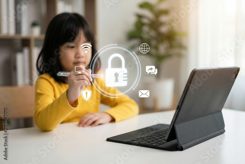 Young girl interacting with digital security padlock interface and tablet computer on desk
