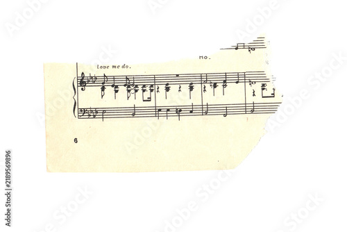 Foto Scrap of old torn music sheet, vintage yellowed ripped paper with notes isolated for design