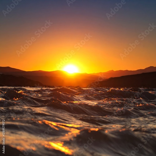 the sun is setting over the ocean