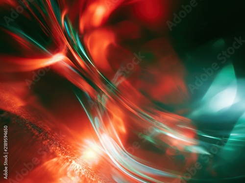 Abstract red and teal light waves on dark background