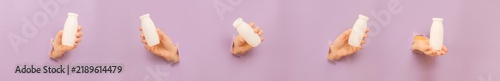 Hands holding yogurt drink bottles appearing through paper holes